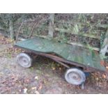 A four wheeled flat bed hand cart/trolley with pneumatic tyres, tubular chassis and handle, the