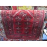A Persian red ground wool rug with multi medallion centre within several repeating borders 95 x 85