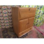 Ercol light elm bureau, the fall front enclosing a part fitted interior over two cupboard drawers