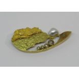 Abstract yellow metal brooch set with a pearl and four graduated brown diamonds