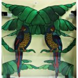 Interesting glass panel with over painted decoration of two opposing parrots sat on palm leaves, 106