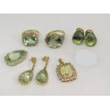 Collection of 9ct fancy dress jewellery set with green gemstones, comprising two rings, a pair of
