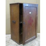 A vintage oak first aid/medicine cabinet of continental origin enclosed by a rectangular panelled