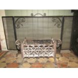 A small cast iron fire basket of rectangular form with scrolled and drop ring finials 56 cm wide (