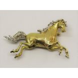 Good quality diamond set brooch modelled as a galloping horse, the mane, tail and hooves highlighted
