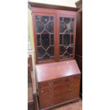 An Edwardian mahogany bureau bookcase, with inlaid detail, showing urns, swags, ribbons, etc,