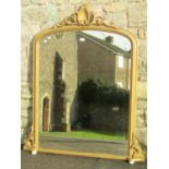 A Victorian overmantel mirror with gilt moulded arched frame, raised shell and scrolling acanthus