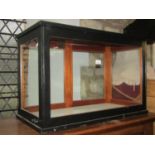 A vintage counter top display case/cabinet with ebonised frame, glazed panels and enclosed by two
