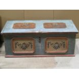 A 19th century European pine blanket box with hand painted finish, hinged lid and candle box to