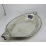 An open elliptical shaped silver dish with scrolled handle and details borders, 33cm max, London