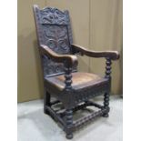 An old English oak Wainscot chair, the back panel with carved geometric, floral detail, the cresting