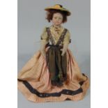 Small French doll with ceramic head,painted features and period traditional dress