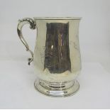 A Georgian silver one pint tankard, the scrolled handle with acanthus detail, engraved with the