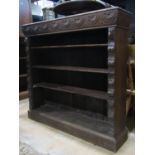 A Victorian carved oak dwarf freestanding open bookcase with lions mask, repeating foliate and
