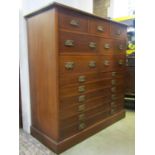 A substantial Edwardian mahogany chest, fitted with an unusual arrangement of thirteen drawers,