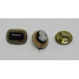 Three antique brooches comprising a gilt metal citrine example, a yellow metal cameo example with