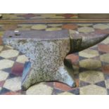 An old heavy cast iron anvil, 62 cm long x 28 cm in height x 31 cm wide