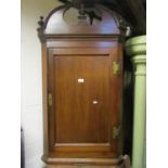 A Georgian mahogany hanging corner cupboard, enclosed by a rectangular moulded panelled door, with