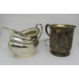 A Victorian silver half pint tankard with embossed and engraved rococo style detail, with ear shaped