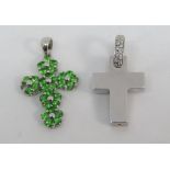 Two 18ct white gold cross pendants; one set with diamonds, the other with green gemstones (one green