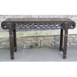 A Chinese hardwood altar table with carved and pierced knotted frieze and raised on four square