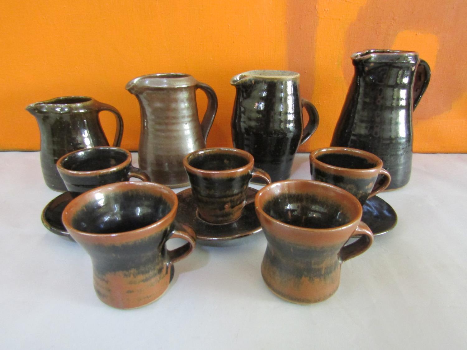 Collection of probably Leach pottery St Ives table wares all in brown glaze comprising four jugs,