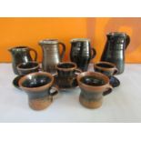 Collection of probably Leach pottery St Ives table wares all in brown glaze comprising four jugs,