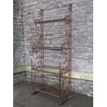 An iron framed freestanding four tier bakers stand with decorative scroll work detail, 85 cm wide