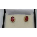 Pair of 9ct oval fire opal stud earrings, 1g