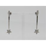 Pair of 18ct white gold diamond set drop earrings of articulated star design, 8g total