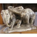 An onyx group of two elephants, 39cm long x 25cm high approx