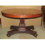 A mid-19th century mahogany centre table, the circular top raised on a square cut column and