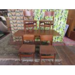 1960s teak extending dining table, together with four teak stuff-over chairs, the table 72cm high