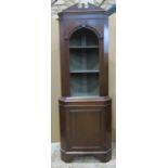A reproduction Georgian style freestanding corner cupboard partially enclosed by a moulded