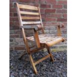 A set of six good quality contemporary teak folding garden armchairs with slatted seats and backs