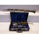 Two clarinets, one of English manufacture complete with case, the second of French manufacture by