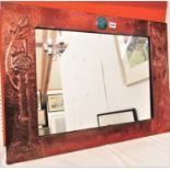 In the manner of Archibald Knox for Liberty - Planished copper rectangular wall mirror, centrally