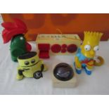 A collection of novelty plastic wares to include a Tomy Robot money box, a Bart Simpson telephone, a