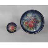A Moorcroft plate in the Finch and Fruit pattern with impressed marks to base and painted