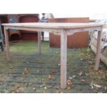 A weathered teak garden table of rectangular form raised on square cut detachable legs, 160cm x 90cm