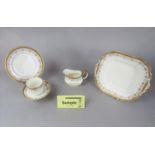 A collection of Aynsley teawares with gilt border decoration including cake plate, milk jug, sugar