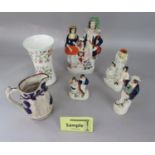 A collection of 19th century Staffordshire wares including a figure group with goat and dog, an