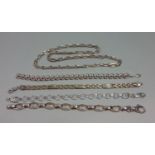 Group of silver jewellery comprising a chain link necklace and four bracelets of various design (5)