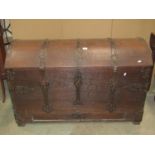 An 18th century oak domed top trunk/coffer with exposed strap work hinges, lasps and fittings and