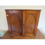 A good quality Victorian mahogany table top cabinet enclosed by a pair of lancet panelled doors,