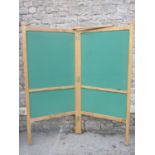 A good quality light oak floorstanding two fold screen/notice board, with chamfered and exposed