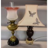 A Victorian brass oil lamp on a vase shaped column, with fluted base, with weighted ceramic foot and