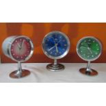 Matched pair of Rhythmn alarm clocks on chrome tulip bases together with a similar Frontier clock (
