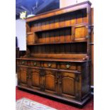 A good quality reproduction Georgian style oak dresser, with distressed finish, the base enclosed by
