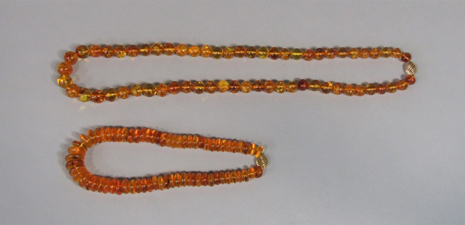 Two graduated amber bead necklaces, each with 9ct clasp (2)